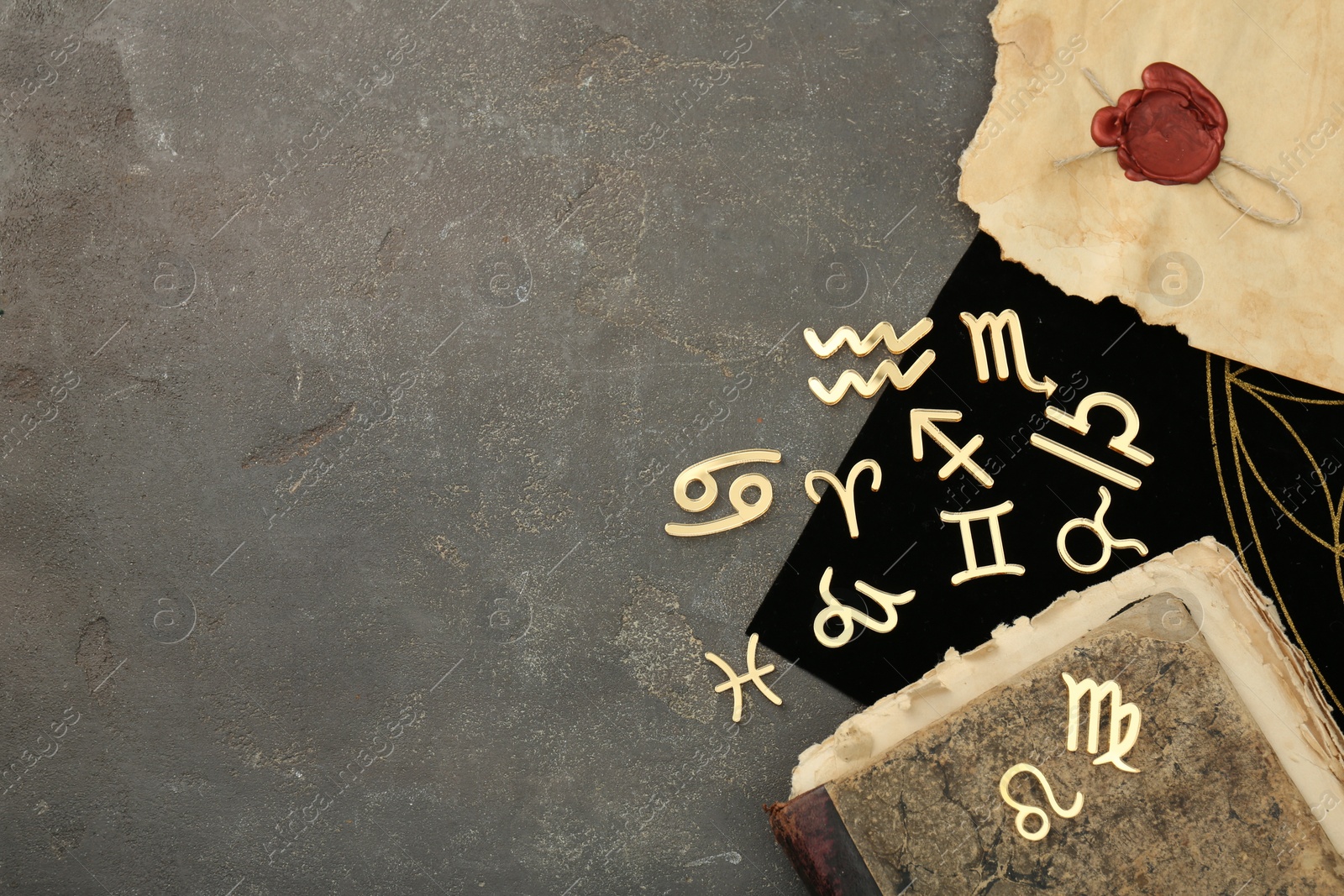 Photo of Flat lay composition with zodiac signs on grey textured table. Space for text