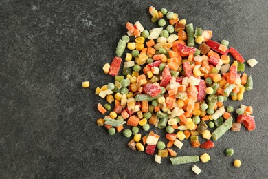 Mix of different frozen vegetables on gray table, top view. Space for text