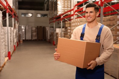 Photo of Worker with cardboard box in warehouse, space for text. Wholesaling