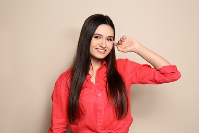 Photo of Portrait of beautiful young woman in stylish clothes on color background