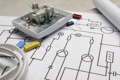 Photo of Wiring diagrams, wires and disassembled light switch on table, closeup
