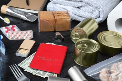 Photo of Disaster supply kit for earthquake on black wooden table