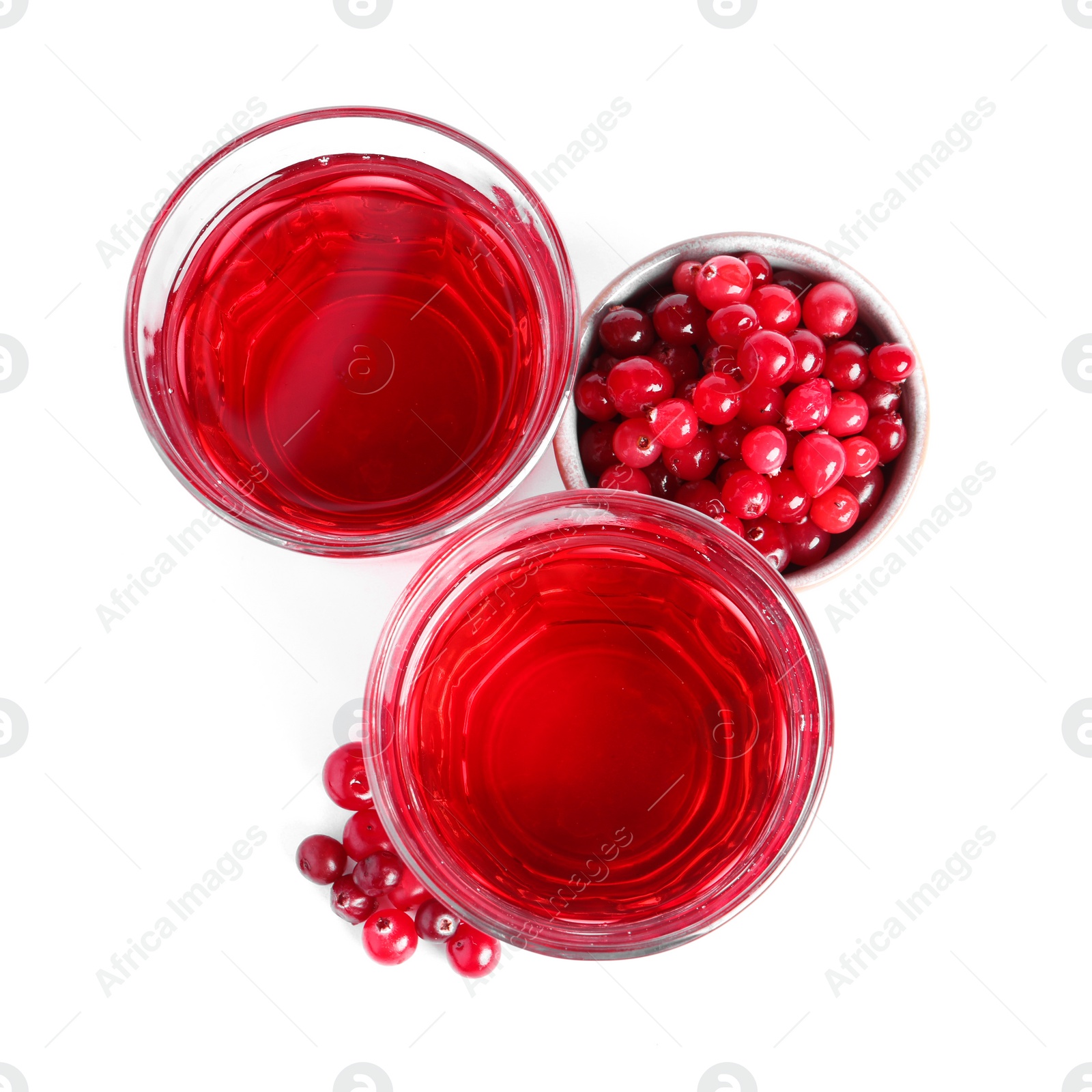 Photo of Tasty cranberry juice in glasses and fresh berries isolated on white, top view