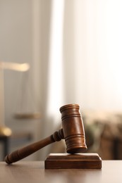 Photo of Law concept. Gavel on wooden table indoors, space for text