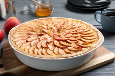 Photo of Tasty apple pie on grey wooden table