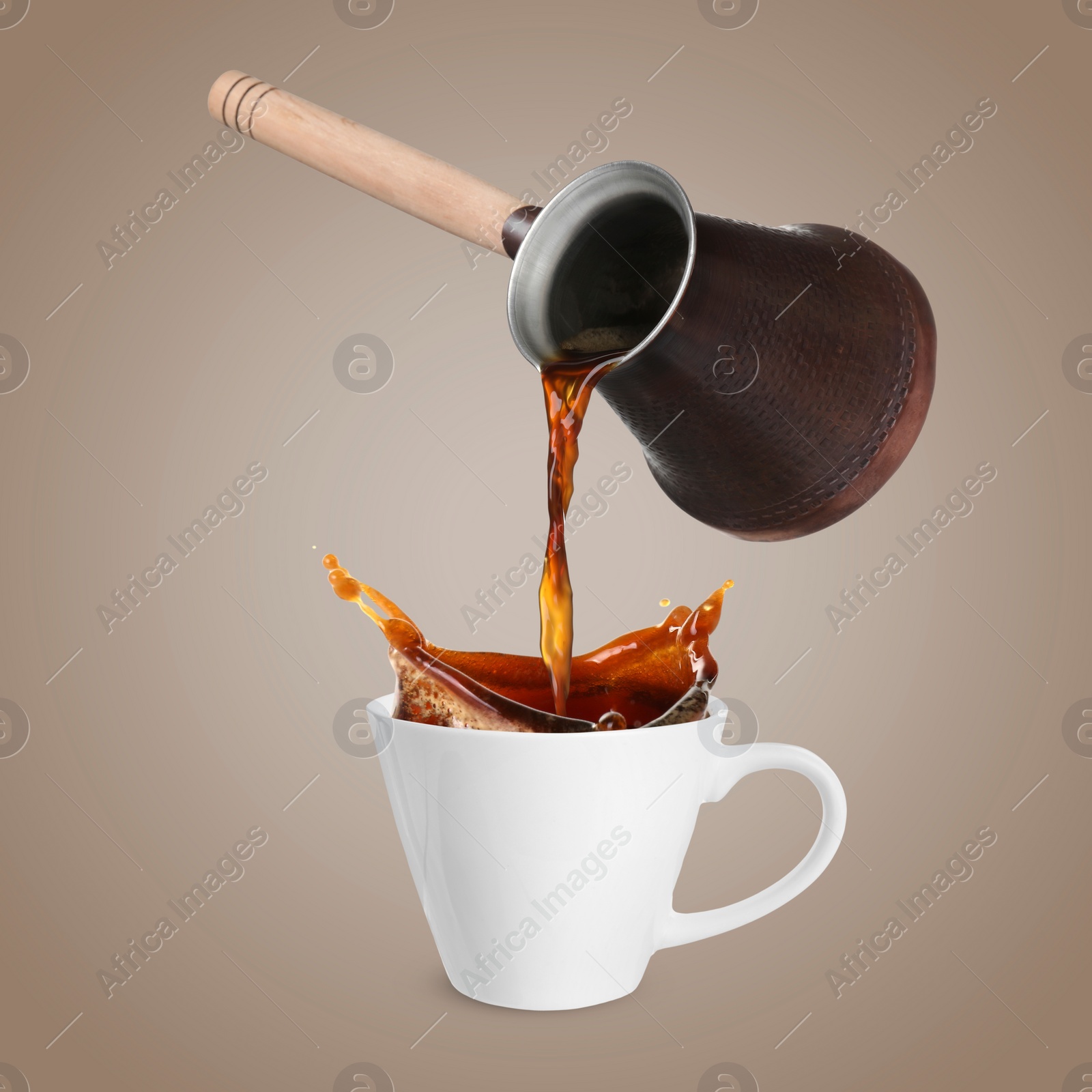 Image of Pouring freshly brewed aromatic coffee from turkish pot into cup. Objects in air on dark dusty beige background