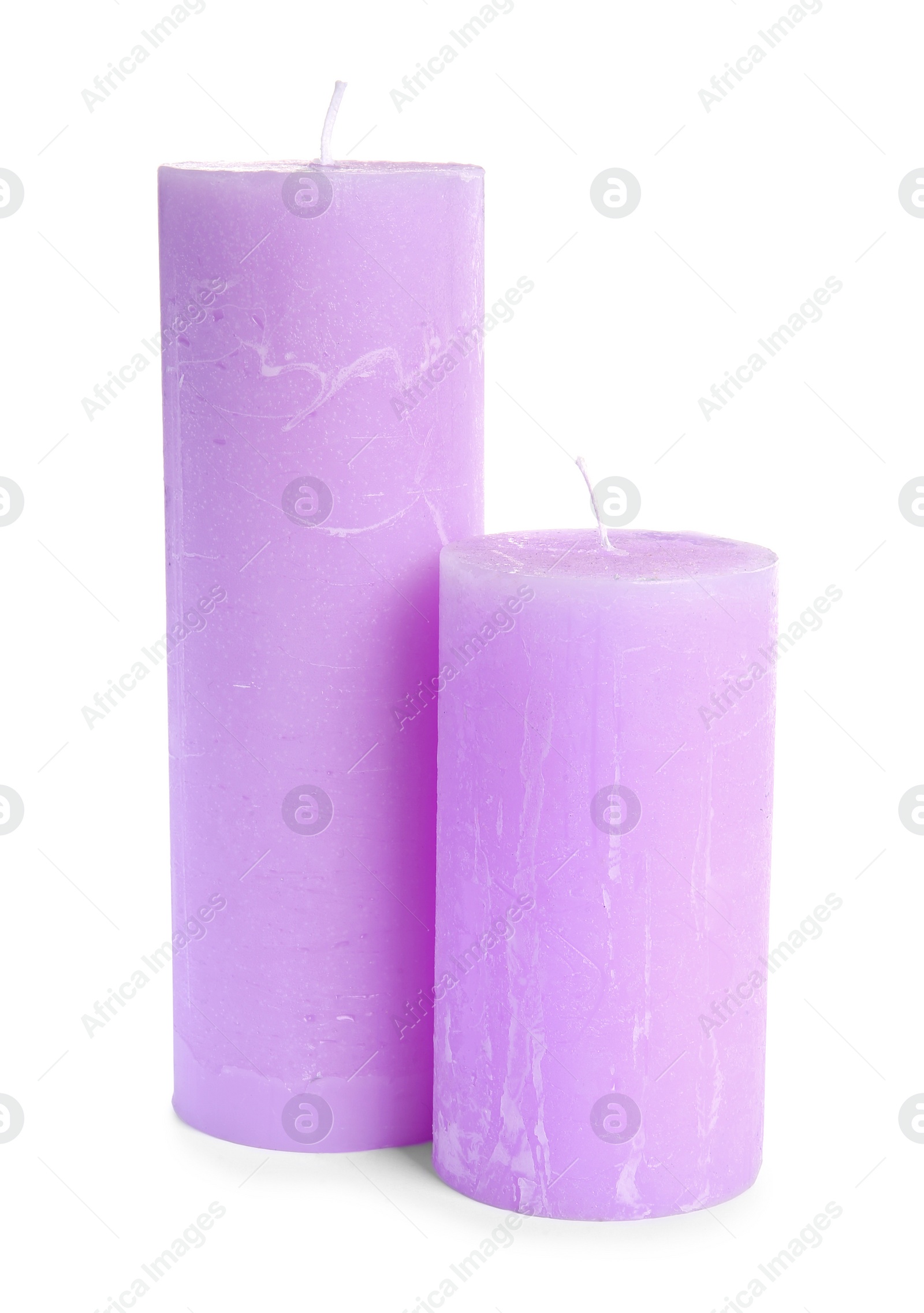 Photo of Two decorative wax candles on white background