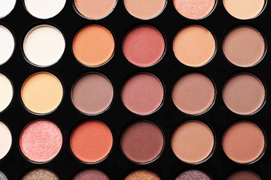 Beautiful eye shadow palette as background, top view