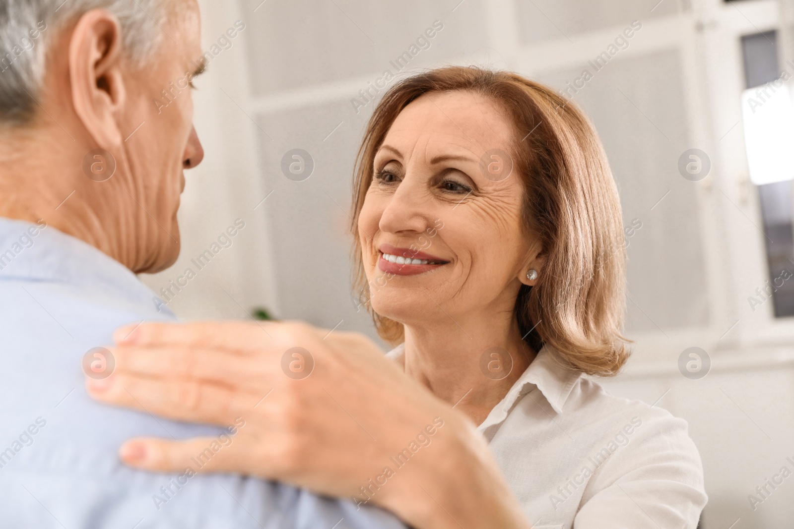 Photo of Happy senior couple dancing together at home, closeup