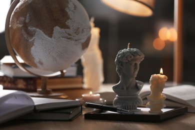 Beautiful David bust candles on table indoors