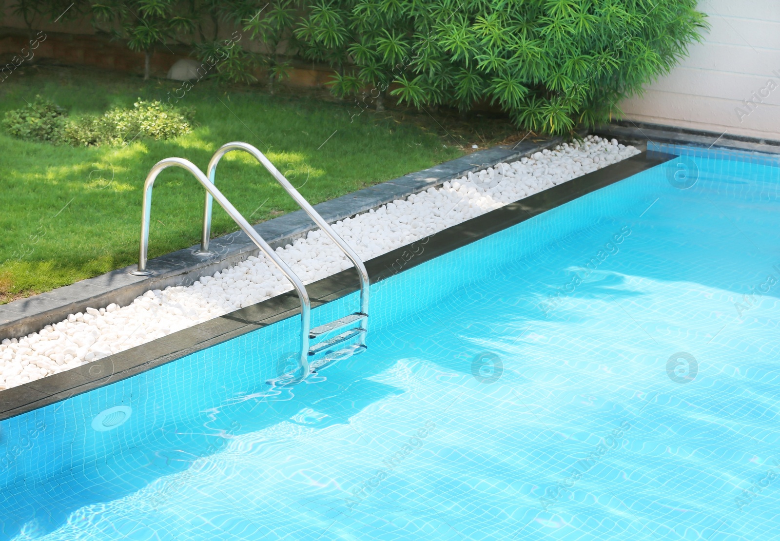 Photo of Modern swimming pool with stairs, outdoors