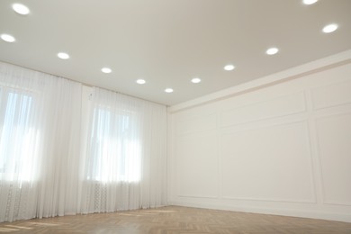 Photo of Empty room with windows and white wall