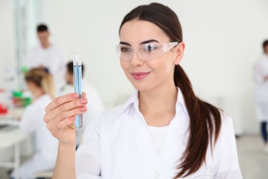 Photo of Portrait of medical student with test tube in modern scientific laboratory