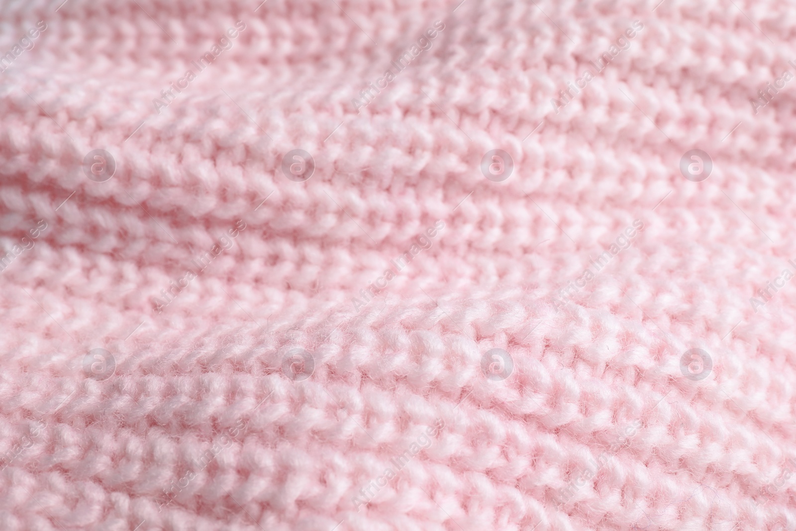 Photo of Pink knitted sweater as background, closeup view