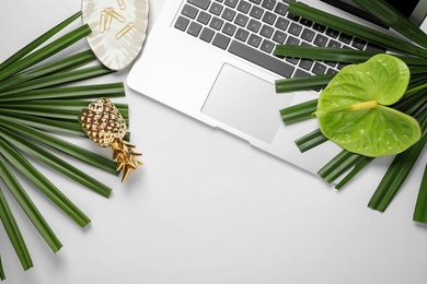 Photo of Creative flat lay composition with tropical flower, foliage and laptop on white background