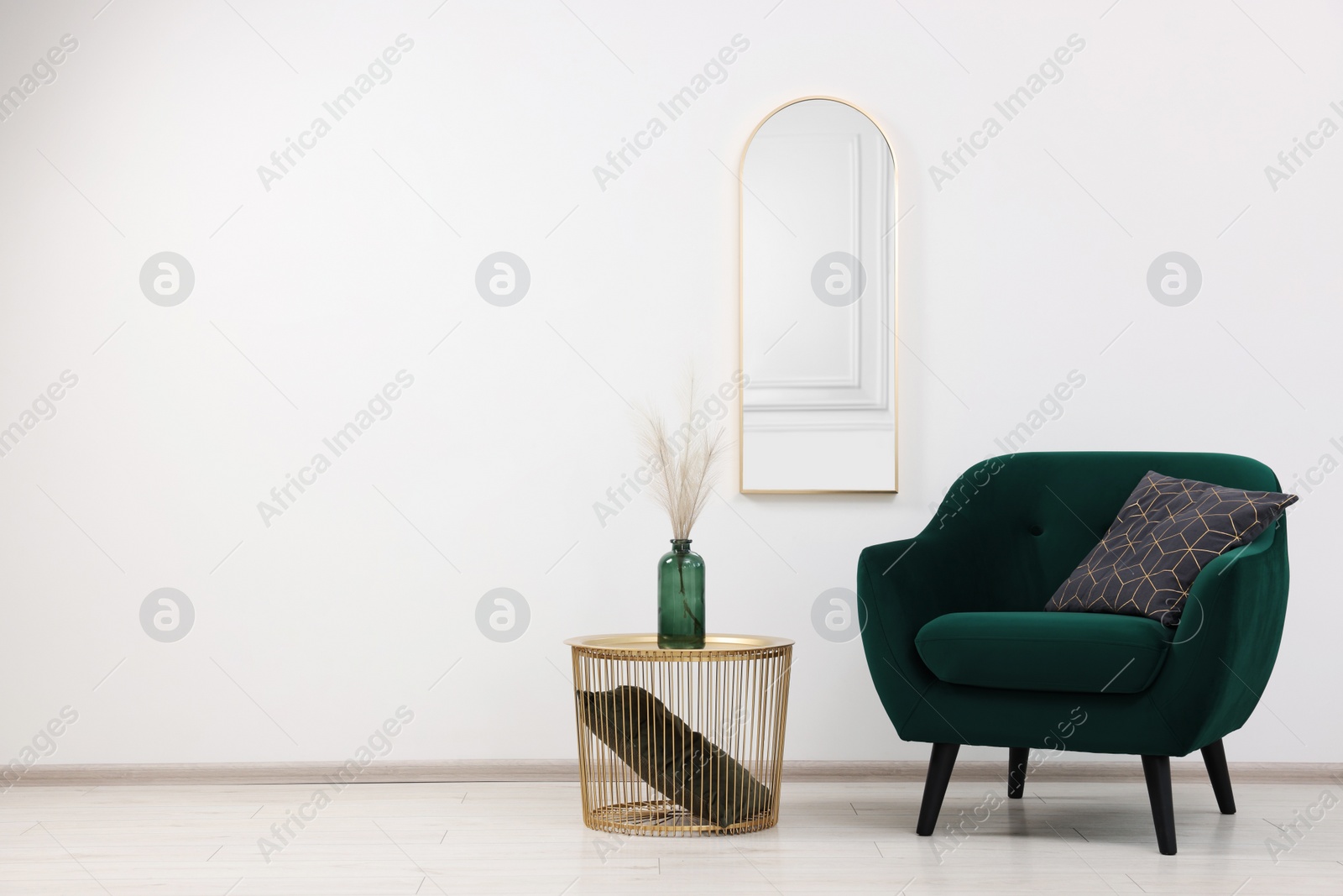 Photo of Stylish room interior with comfortable armchair and side table, space for text