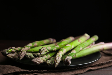 Photo of Fresh raw asparagus on table, closeup view