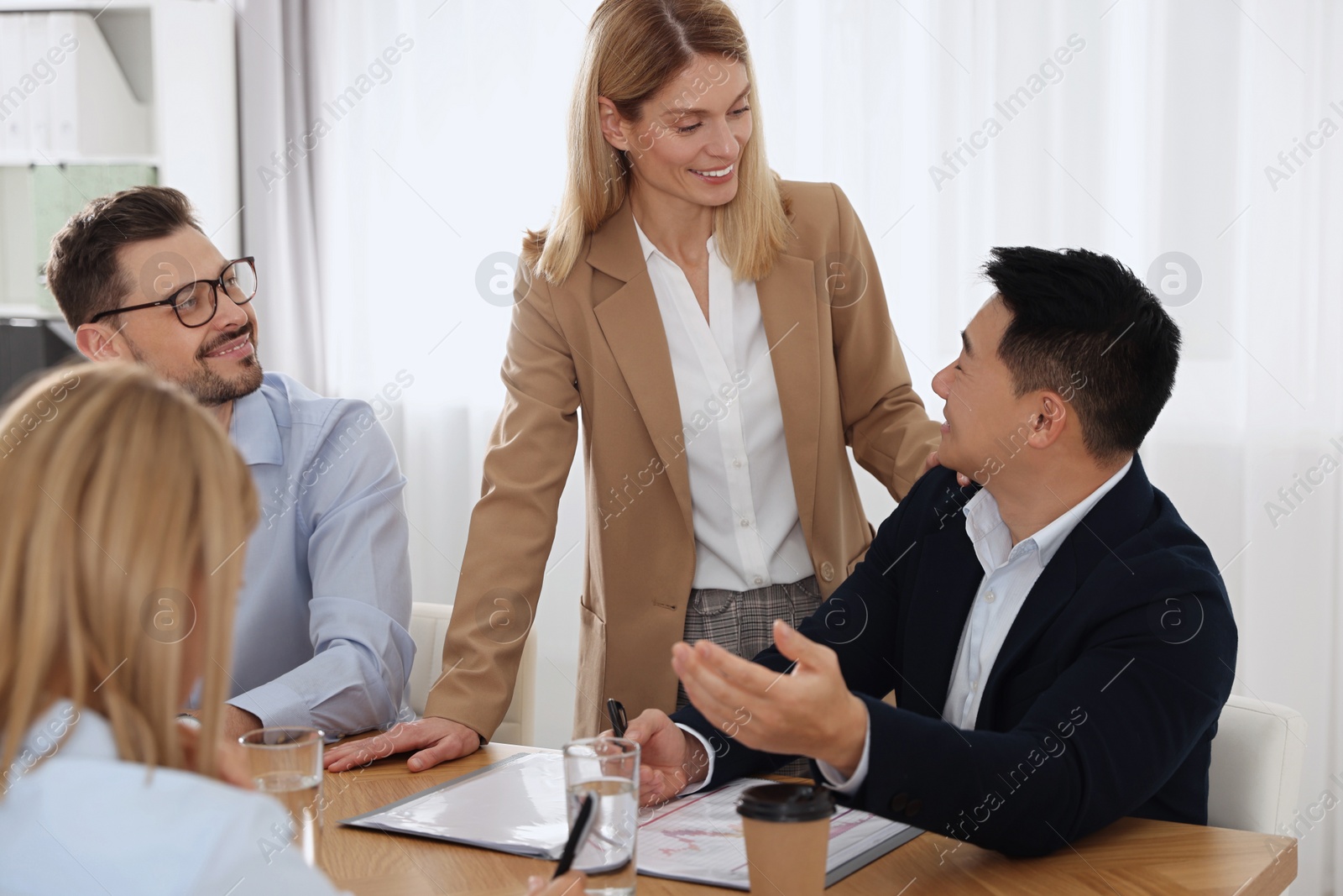 Photo of Businesswoman having meeting with her employees in office