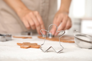 Photo of Making homemade Christmas cookies. Dough and gingerbread man cutter on table, closeup