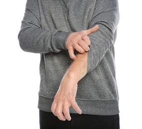 Mature man scratching arm on white background, closeup. Annoying itch