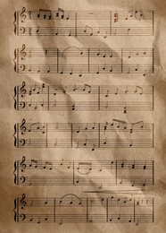 Image of Sheet music. Different musical symbols combined into composition on crumpled paper