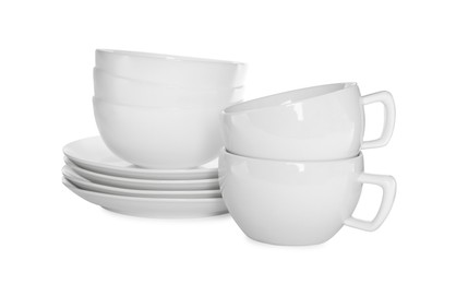 Photo of Stacked plates and cups on white background