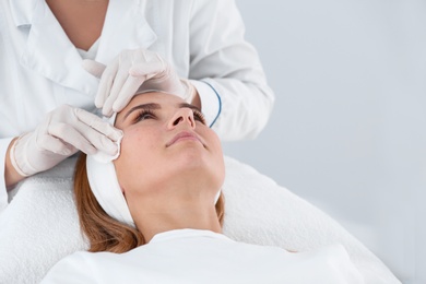 Woman undergoing face biorevitalization procedure in salon. Cosmetic treatment