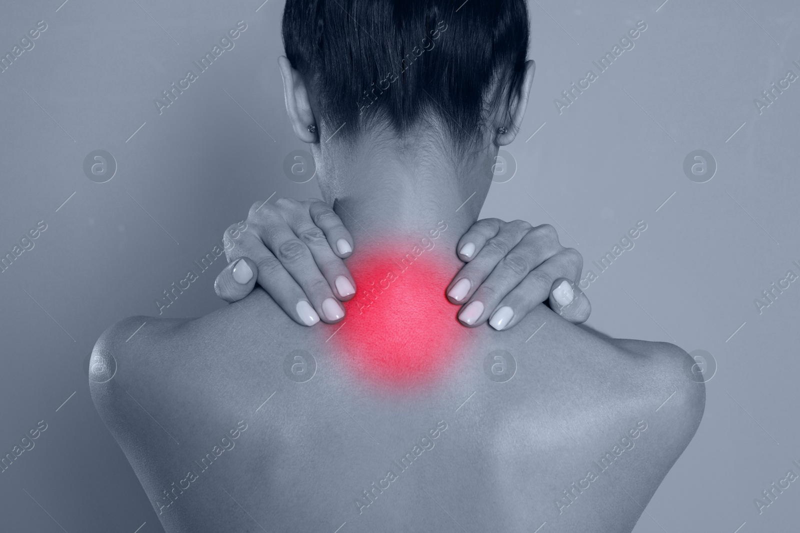 Image of Woman suffering from neck pain on grey background, closeup