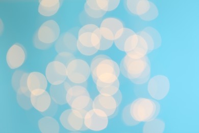 Blurred view of beautiful lights on blue background