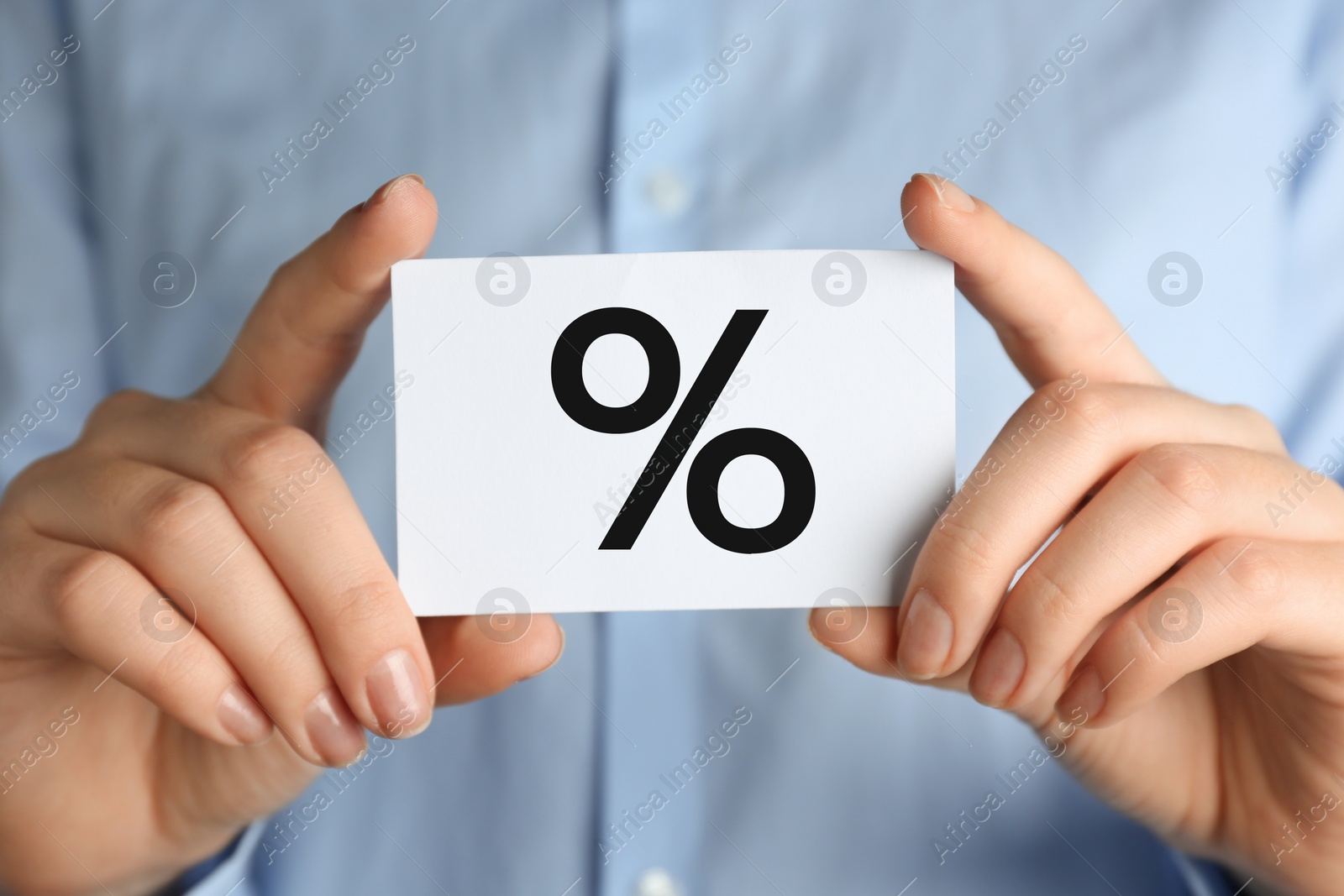 Photo of Woman holding card with percent sign, closeup