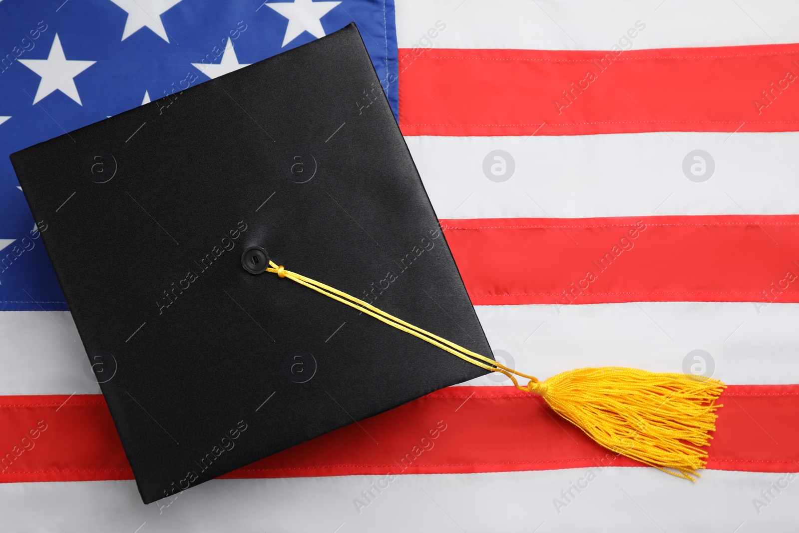 Photo of Black graduation hat on national USA flag, top view