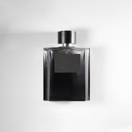 Photo of Luxury men`s perfume in bottle on white background, top view