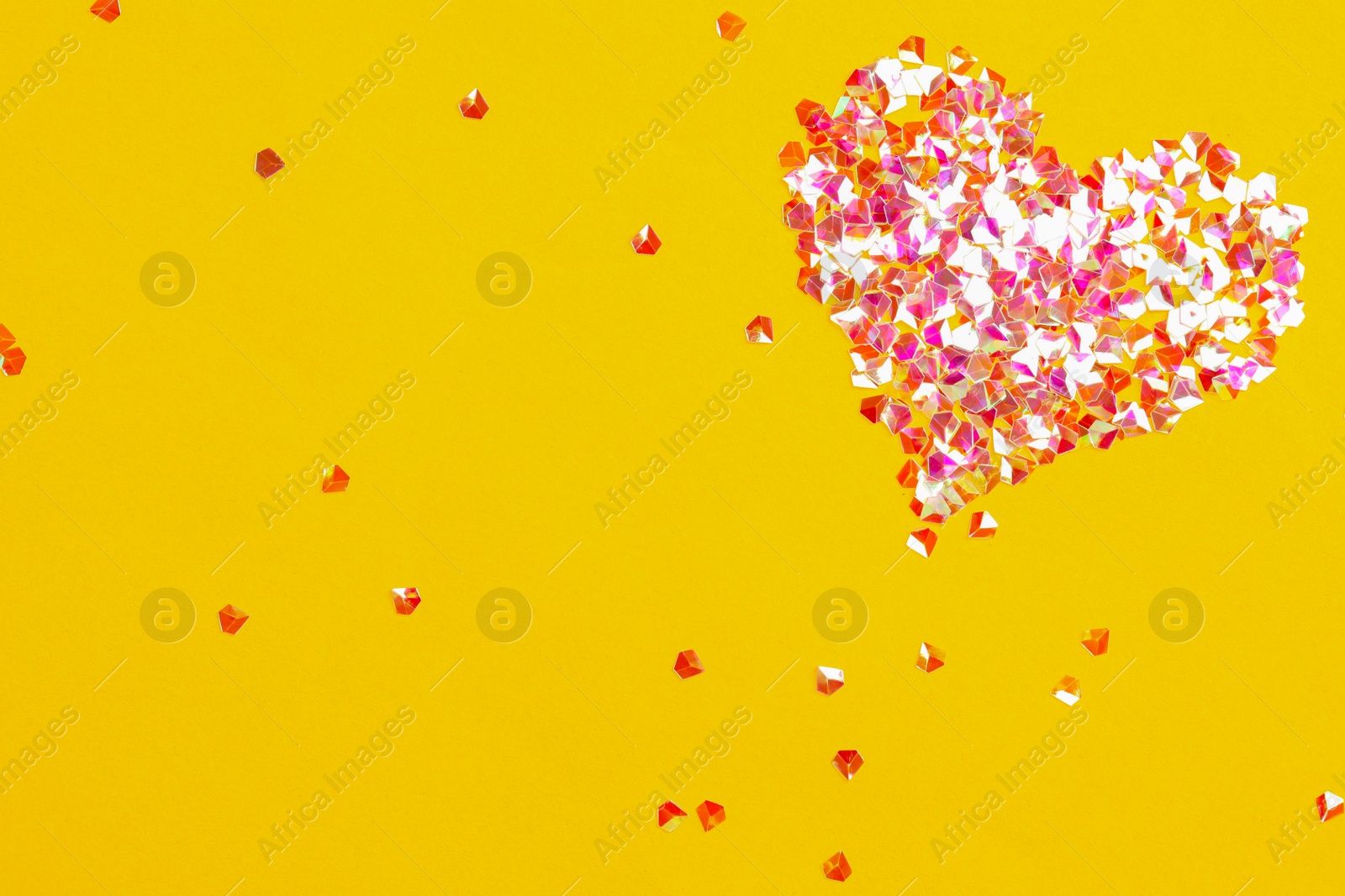 Photo of Heart made with shiny glitter on yellow background, flat lay