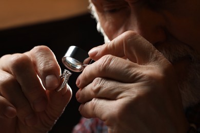 Professional jeweler working with ring, closeup view