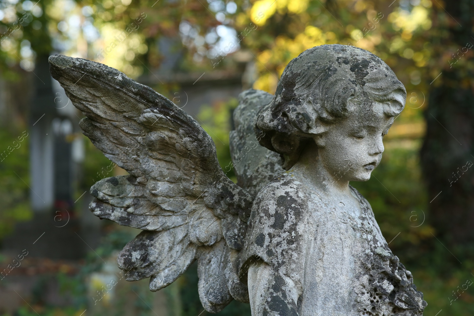 Photo of Beautiful statue of angel at cemetery. Religious symbol