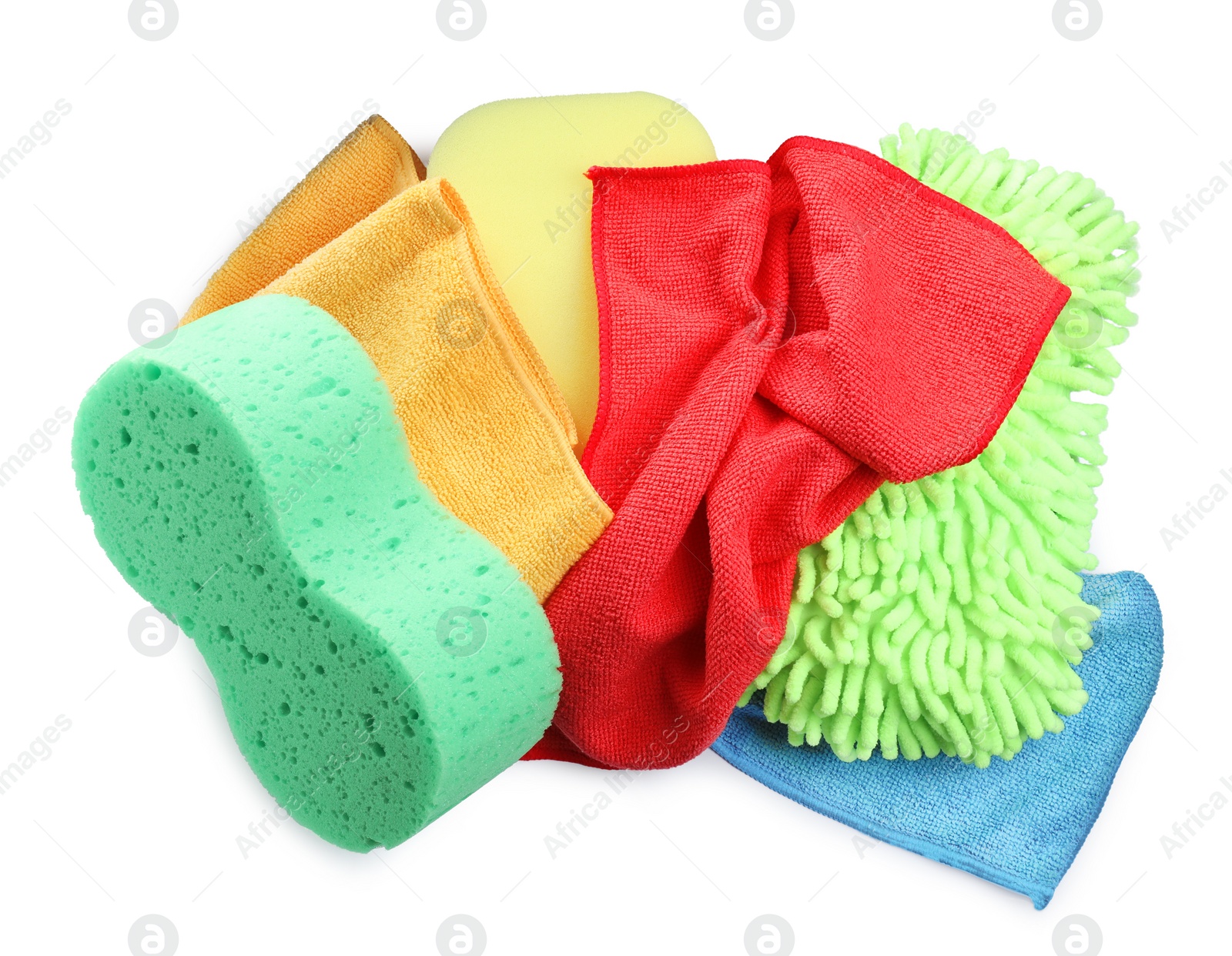 Photo of Sponges, cloths and car wash mitt on white background, top view