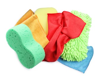 Sponges, cloths and car wash mitt on white background, top view