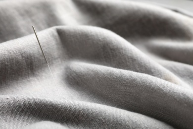 Photo of Needle for acupuncture on gray fabric