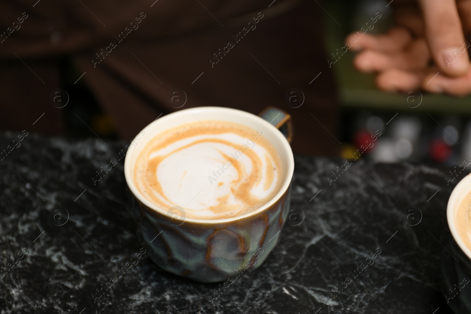 Photo of Cup of fresh aromatic coffee on table at cafe