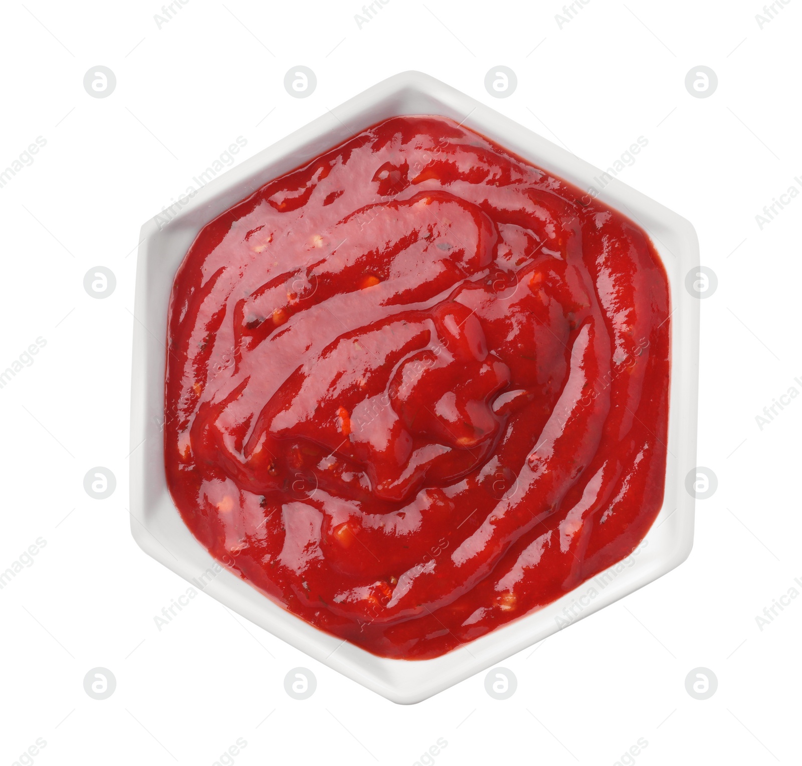 Photo of Bowl with red sauce isolated on white, top view