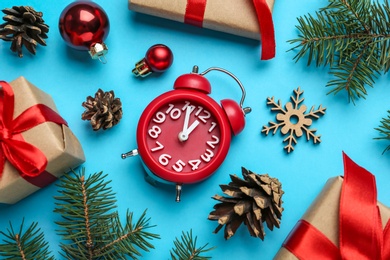 Flat lay composition with Christmas gifts and alarm clock on light blue background, flat lay. Boxing day