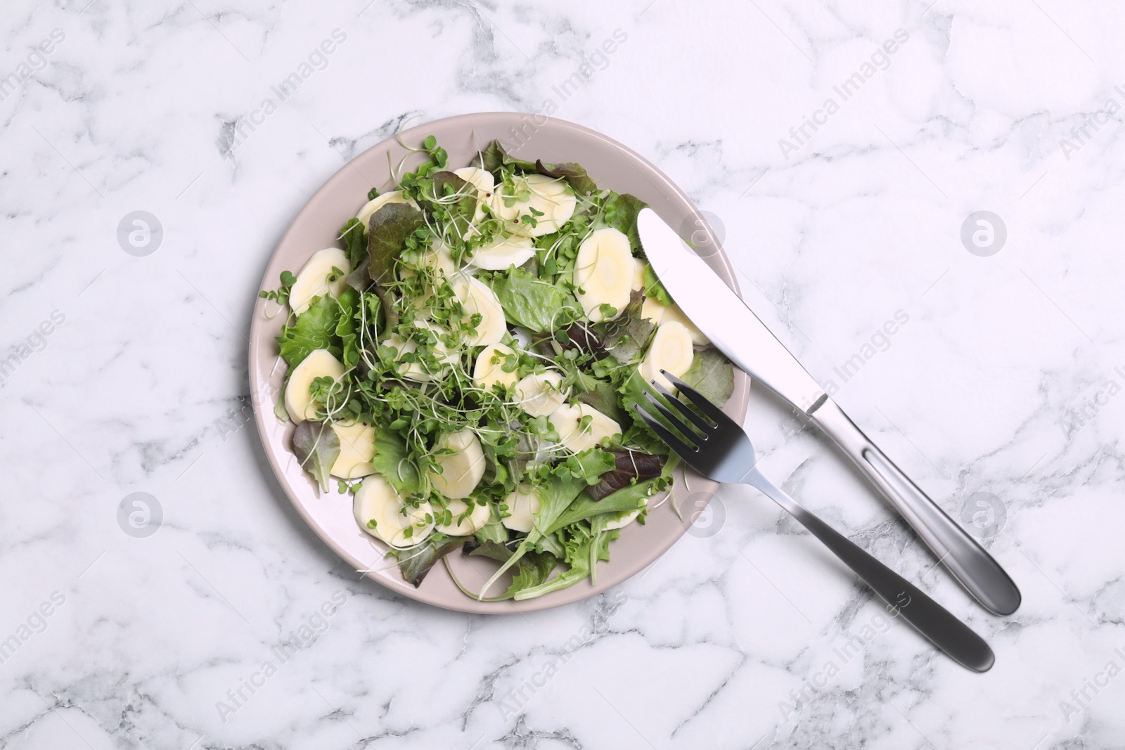 Photo of Delicious carrot salad served on white marble table, flat lay