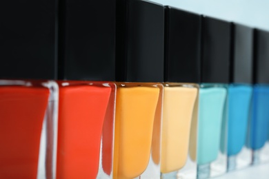 Photo of Bottles of bright nail polish, closeup. Space for text