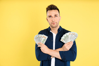 Photo of Man with cash money on yellow background