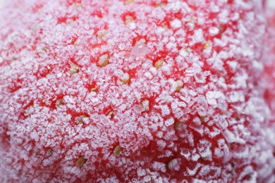 Texture of strawberry covered with hoarfrost as background, macro view. Frozen berry