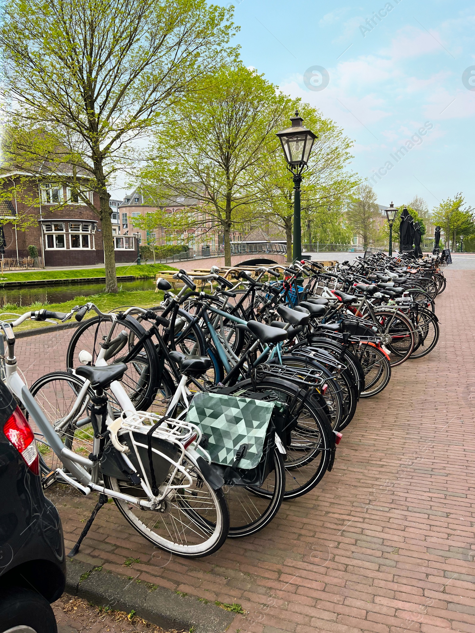 Photo of Many different bicycles parked on city street