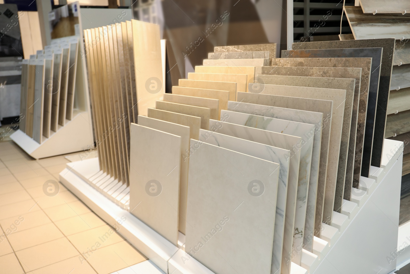 Photo of Assortment of tiles in store. Many different samples indoors