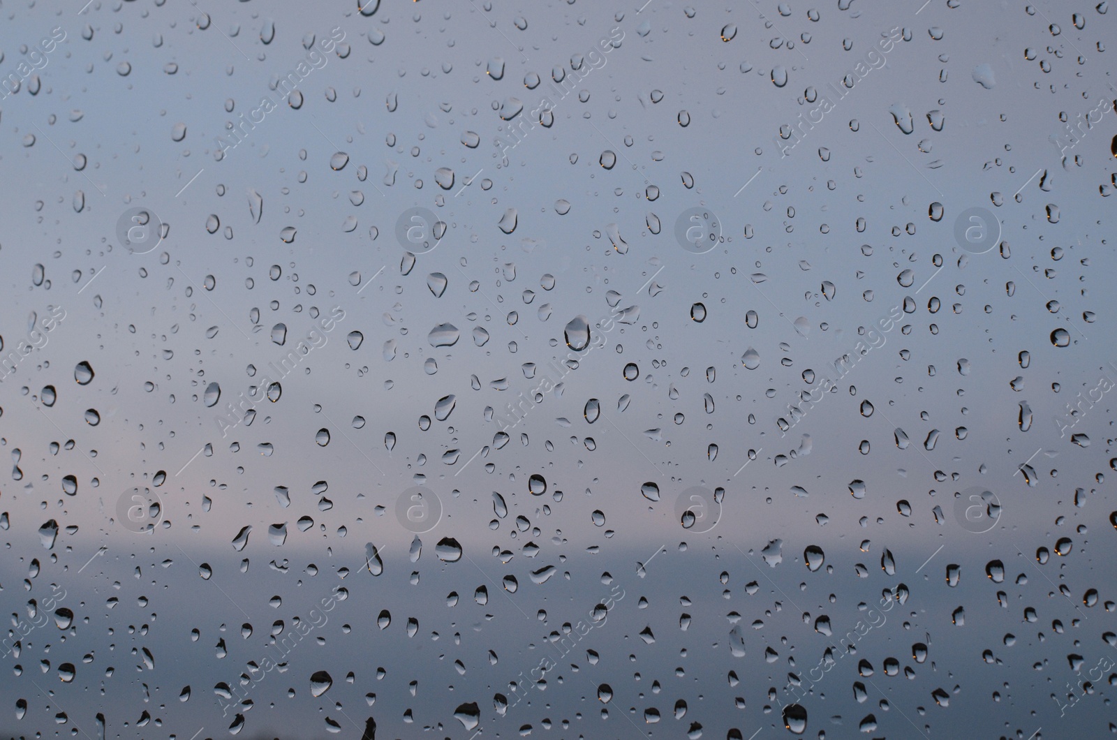 Photo of Window glass with water drops, closeup. Rainy weather