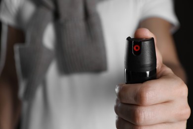 Man using pepper spray, closeup. Space for text