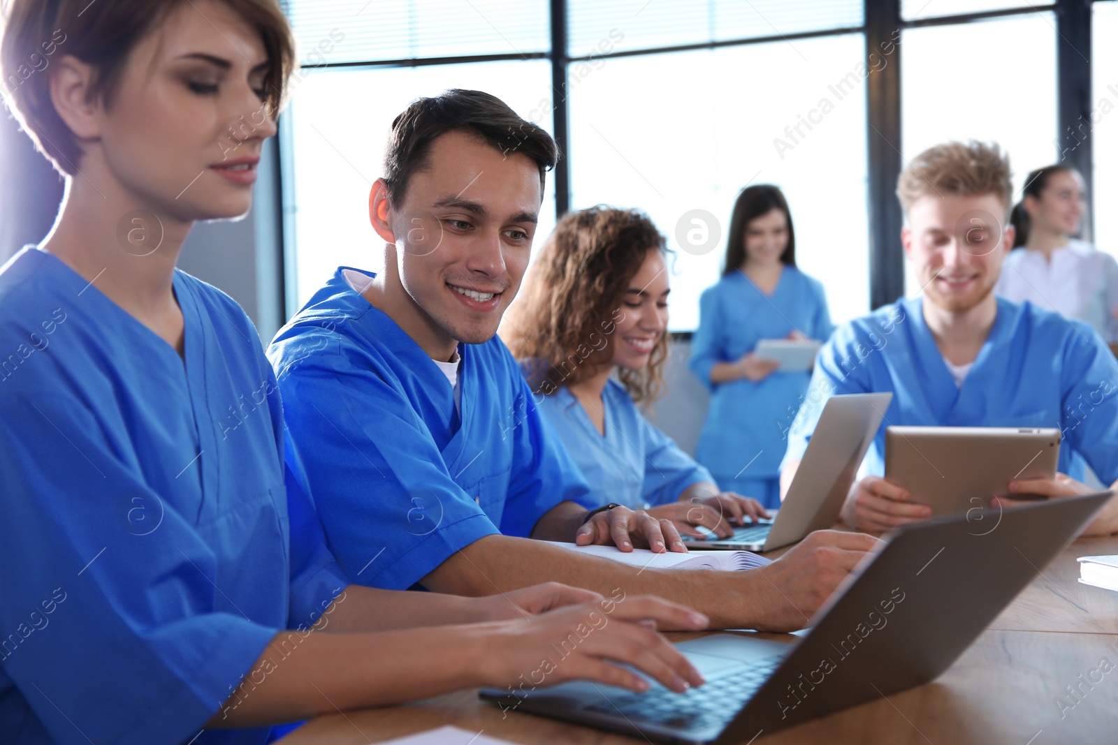 Photo of Group of smart medical students with gadgets in college